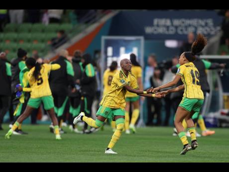 Jamaica's Deneisha Blackwood and Jamaica's Tiernny Wiltshire celebrate after drawing 0-0 with Brazil in the Women's World Cup Group F football match in Melbourne, Australia, yesterday. Jamaica advanced to the round of 16, where they will face Colombia.