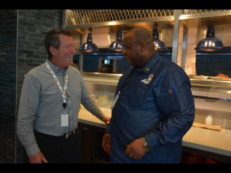 Mark Sutherland (left), vice-president, Express Caterings and Executive Chef, Dwayne Bell of Bob Marley’s One Love Restaurant.