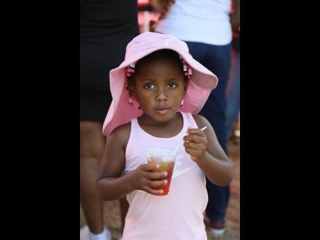 Three-year-old Charleigh Dupie cools down with a snow cone during the Denbigh Agricultural, Industrial and Food Show 2023.