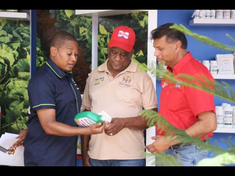 Floyd Green, minister of agriculture, fisheries and mining, in discussion with Franklyn Witter, state minister in the Ministry of Agriculture, Fisheries and Mining, and Ian Parsard, group senior vice president of finance and planning at Jamaica Broilers Gr