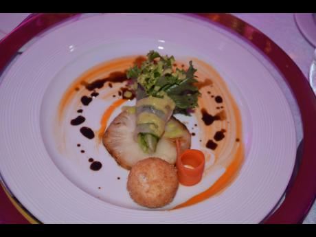 Chef Brian Lumley’s composed salad of mixed organic greens, grilled pineapple, breaded goat cheese, carrot ribbons and passion fruit roast scallion dressing.