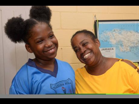 Top girl in the Primary Exit Profile exam at Garden Hill Primary and Infant School, Kiera Thomas, and her mother, Latoya Cameron, celebrate her success.