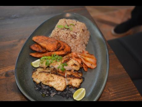 Pimento snapper, served with island rice, fried plantains and simmered up black beans.