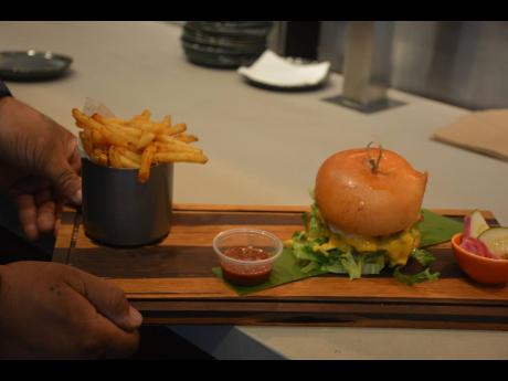 The big cheeseburger served with jerked fries.