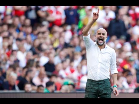 Manchester City's manager Pep Guardiola gives instructions to his players during the English FA Community Shield final  match between Arsenal and Manchester City at Wembley Stadium in London, Sunday, August 6, 2023.