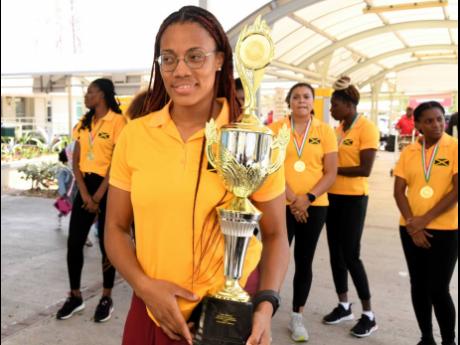Captain Sasha-Lee Thomas with the championship trophy at the Norman Manley International Airport on Monday, July 31 shortly after Jamaica’s women’s team returned home from the XVIII CAZOVA Senior Caribbean Volleyball Championship.