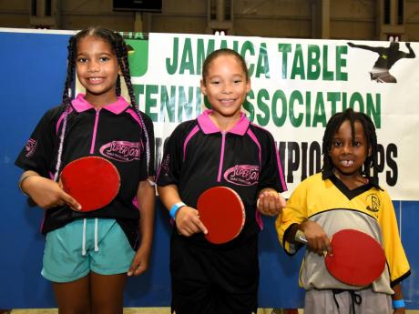 Axys Johnson (centre) won the girls’  under-9 title at the National Junior and Senior Table Tennis Championships yesterday. Isabella Campbell (left) was second and Alexandra Montique (right) placed third.