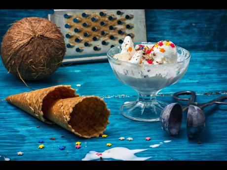 Coconut ice cream in bowl and two waffle cones.