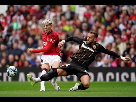 Manchester United’s Alejandro Garnacho (left) and RC Lens’ Jonathan Gradit battle for the ball during a pre-season friendly match at Old Trafford, Manchester, England, on Saturday August 5, 2023. 