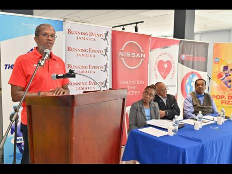 Running Events Jamaica director, Alfred Francis (left), speaks during the launch of the Blue Run 5K Road Race at Fidelity Motors Ltd on Hanover Street, downtown, Kingston yesterday.