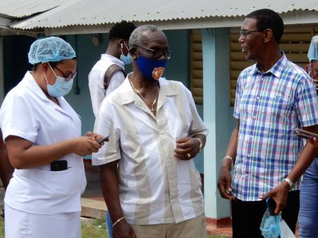 Local Government Minister Desmond McKenzie (centre) in conversation with Alicia Drummond-Knight, matron at the St Ann Infirmary, and St Ann’s Bay Deputy Mayor Dallas Dickenson. 
