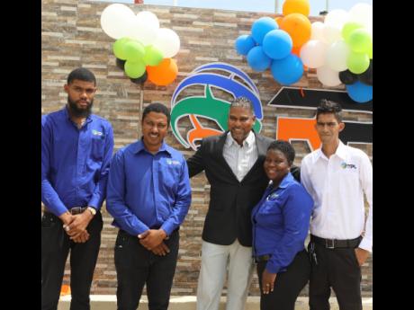 Regency Petroleum CEO Andrew Williams (centre) shareing an exciting moment with staff at the opening of Regency Petroleum Limited’s first petrol station at Paradise, Westmoreland, on Wednesday.