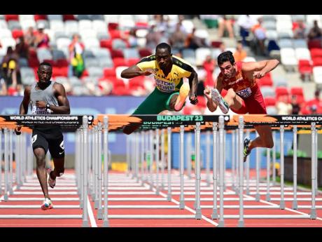 Jamaica’s Hansle Parchment (centre) competing in heat one of the men’s 110m hurdles at the 2023 World Athletics Championships yesterday. Parchment won the heat in 13.30 seconds and secured his spot in the semi-finals.