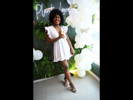 Travel connoisseur and wellness content creator Chanel DaCosta is all smiles with a glass of bubbly.