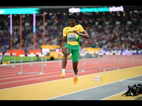Jamaica's Jaydon Hibbert grabs his hamstring during his first attempt at the men's triple jump final at the World Athletics Championships inside the National Athletics Centre in Budapest, Hungary.