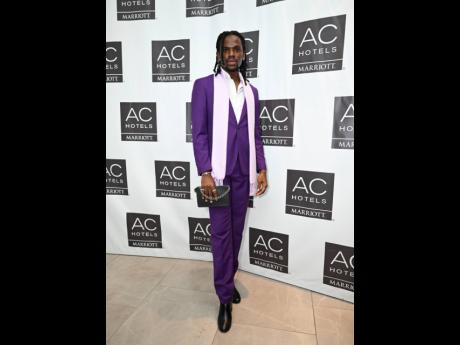 The Walk with Jermaine Dyer’s eponymous owner, pageant coach Jermaine Dyer, wears a casual purple suit, skipping the tie and adding a lavender scarf in a classic drape for a touch of luxury. 