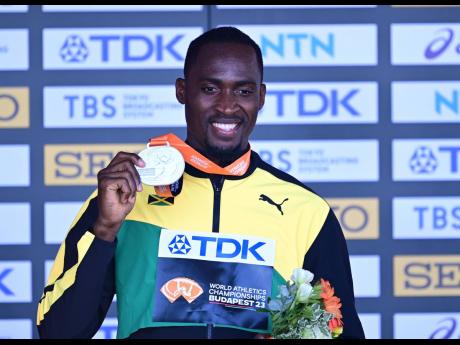 Jamaica’s Hansle Parchment shows off the World Athletics Championships silver medal he earned for finishing second in the 110-metre hurdles final inside the National Athletics Centre on Tuesday.