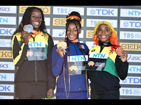 From left: Jamaica’s Shericka Jackson (silver), the United States’ Sha’Carri Richardson (gold), and Shelly-Ann Fraser-Pryce (bronze) celebrate the medals they mined during Monday’s World Athletics Championships 100-metre final during a medal presen