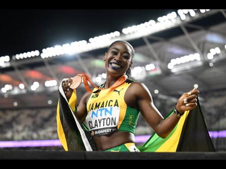 Jamaica’s Rushell Clayton celebrates with her bronze medal after finishing third in the women’s 400m hurdles final at the World Athletics Championships in Budapest, Hungary, yesterday.