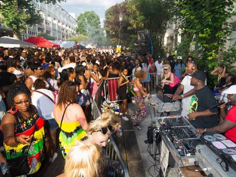 Persons enjoy the music on offer by sound-system deejays at a past staging of the Notting Hill Carnival.