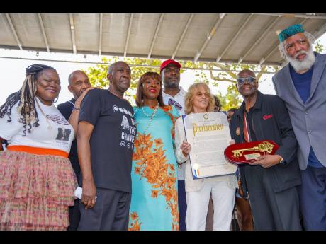 Persons gather for a quick photo with the symbolic Key to the City and official Proclamation posthumously awarded to civil rights activist, and entertainer Harry Belafonte by New York City Mayor Eric Adams.