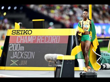 Shericka Jackson poses by the clock after registering a Championship Record 21.41 seconds to secure the women’s 200m gold medal at the World Athletic Championships in Budapest, Hungary yesterday.