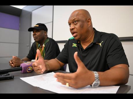 Technical leader for the Jamaican team at the World Championships in Budapest, Hungary, Maurice Wilson (right), speaking at a press conference held at the team hotel yesterday. At left is media liaison Dennis Gordon.