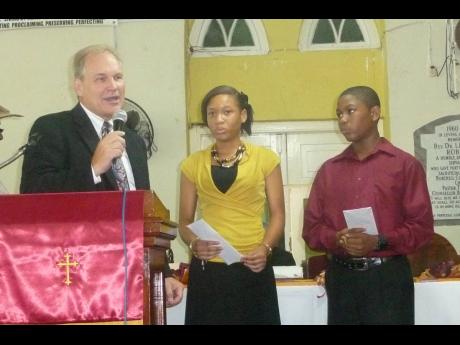 
Ray Matteson (left), great-great-great-grandson of Burchell Baptist Church founder, Thomas Burchell, makes a brief address during the church’s 190th anniversary service, in Montego Bay, on Sunday, September 28, 2014. Looking on are church members Tishel