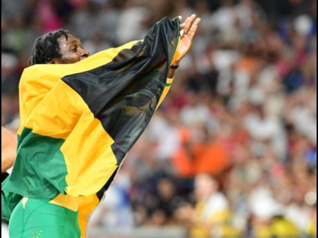 Gladstone Taylor/Multimedia Photo Editor 
Antonio Watson, draped with the Jamaican flag, celebrates with the crowd at the World Athletics Championships moments after winning the 400 metres title inside the National Athletics Centre in Budapest, Hungary, on