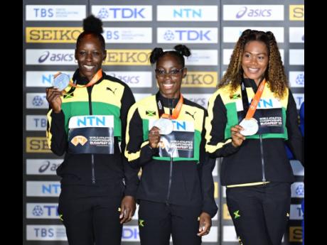 Jamaica’s 4x100m relay team of Shericka Jackson, Shashalee Forbes and Natasha Morrison. Shelly-Ann Fraser-Pryce was absent from the medal ceremony after suffering an injury 	
during the race. 