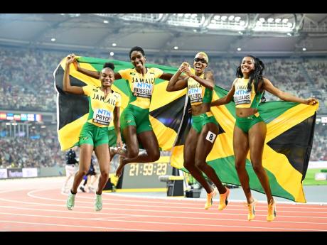 Silver medallists in the women’s 4x400m relays Jamaica’s Nickisha Pryce, Janieve Russell, Candice McLeod and Stacey-Ann Williams. 