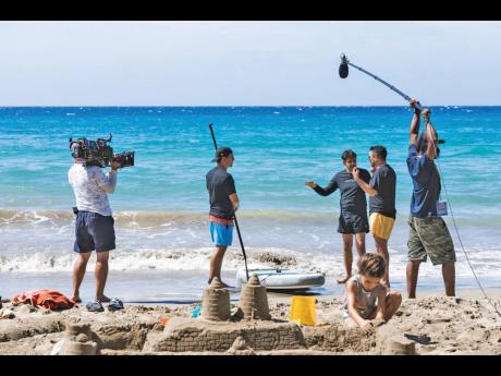 M-1 Productions’ Andrew Campbell (right) on boom during the filming of ‘De Viaje con los Derbez’ on location in Jamaica. 
