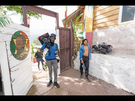 M-1 Productions’ Dondre Maxwell (left) on grip during the filming of ‘De Viaje con los Derbez’ on location in Jamaica.