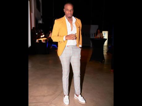 Jermaine Blair, regional director, Miss Universe Jamaica, exudes suave sophistication in fitted plaid pants complemented by a tailored mustard blazer.