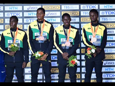 Members of Jamaica’s  4x100m men’s team with their bronze medals in Budapest, Hungary yesterday. From left:  Rohan Watson, Ryiem Ford, Oblique Seville and Ackeem Blake. 