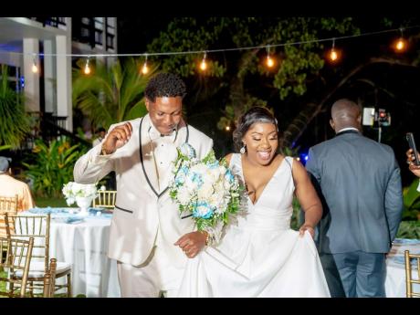  The happy couple, Llaurence and Jemeta Whyte, make their first entrance as husband and wife.