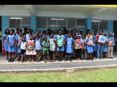 New and returning students of Sheffield Primary School in Westmoreland showing off their new school backpacks, books, pens and pencils gifted to them by the Connell family, led by Dr Norval Connell, who is also a past student of the school.