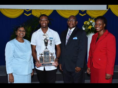 Top Nursing Student at Northern Caribbean University, Chevaugn Thomas (second left), celebrates with his trophy at the recent Pinning ceremony held at the Manchester-based institution. Sharing the moment (from left) are Associate Provost for Academic Affai