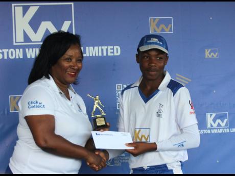 Simone Murdock (left), corporate Services and Client Experience Manager at Kingston Wharves Limited, presents Manchester U15 captain Demario Hall with one of his many awards following the team’s eight-wicket win over St Mary in the final of the Kingston 