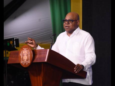 Tourism Minister Edmund Bartlett addressing a town hall at the Harmony Beach Park in Montego Bay, St James, on Thursday.