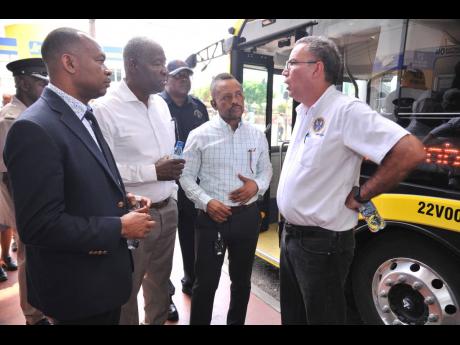 
From left: Ralston Smith, managing director of the Transport Authority; Owen Ellington, chairman of the Transport Authority; and Keith Blake, manager of the Jamaica Urban Transit Company, Half-Way Tree and Cross Roads; and Daryl Vaz, minister of science, 