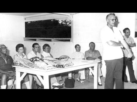 In this 1974 photo Edward Coyne, Vice President and resident manager of Kaiser Bauxite, speaks to STAR Boys at their annual outing at Puerto Seco, Discovery Bay. Standing at his left is Arthur Chin Lenn, circulation manager of the Gleaner Company. Seated f