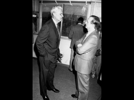 Prime Minister Michael Manley (left) and Opposition Leader Edward Seaga discussing the prime minister’s health in the lobby of Gordon House on April 19, 1990.