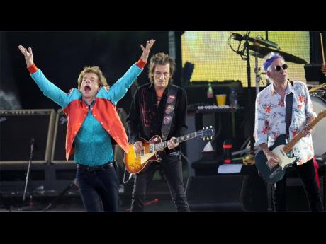 From left: Mick Jagger, Ronnie Wood and Keith Richards of the band, The Rolling Stones, perform onstage.
