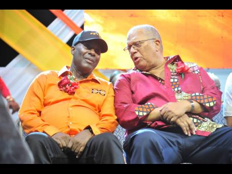 Dr Peter Phillips (right), former president of the PNP, speaks with Councillor Dennis Gordon (left), constituency chairman, during the East Central St Andrew Annual Constituency Conference at Jacisera Park on Sunday.