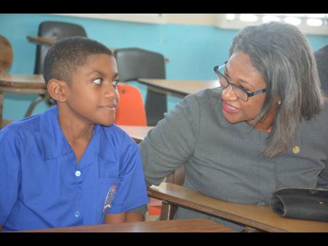 Shernette Crichton and her son Joshua, who she enrolled at the Roman Catholic-operated Monsignor Gladstone Wilson College.