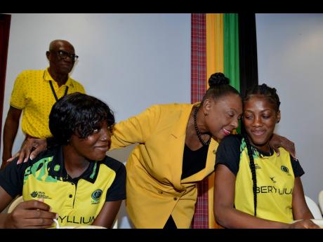 Minister of Culture, Gender, Entertainment and Sport, Olivia Grange, greets  Sunshine Girl Latanya Wilson (right) and Kimone Shaw (left) during a courtesy call at the minister’s office in New Kingston yesterday.