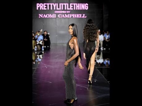 Supermodel-turned-creative director Naomi Campbell took the runway to close the show in a backless black embellished mesh high-neck maxi.