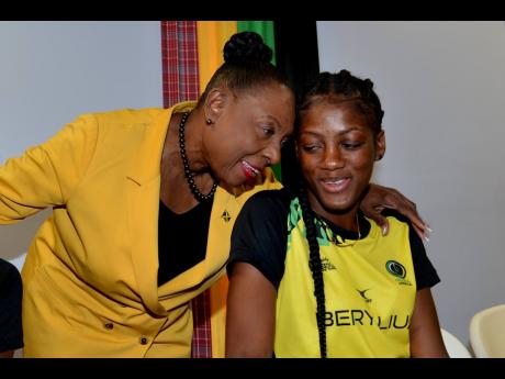 Minister of Culture, Gender, Entertainment and Sport, Honourable Olivia Grange greeted Sunshine Girl Latanya Wilson (right) during a courtesy call at the minister’s office in New Kingston on Tuesday.