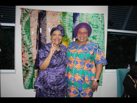 Executive Director at the Jamaica Business Development Corporation Valerie Veira (left), and Nigerian High Commissioner to Jamaica Dr Maureen Tamuno at the opening of Alao Luqman Omotayo’s batik fabric solo exhibition on Monday, August 28 inside The Univ